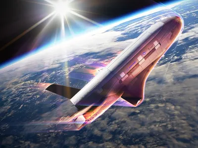 An artist&#39;s rendering of the X-37B conducting an aerobraking maneuver using the drag of Earth&#39;s atmosphere, with the bottom of the craft glowing red as it heats up.