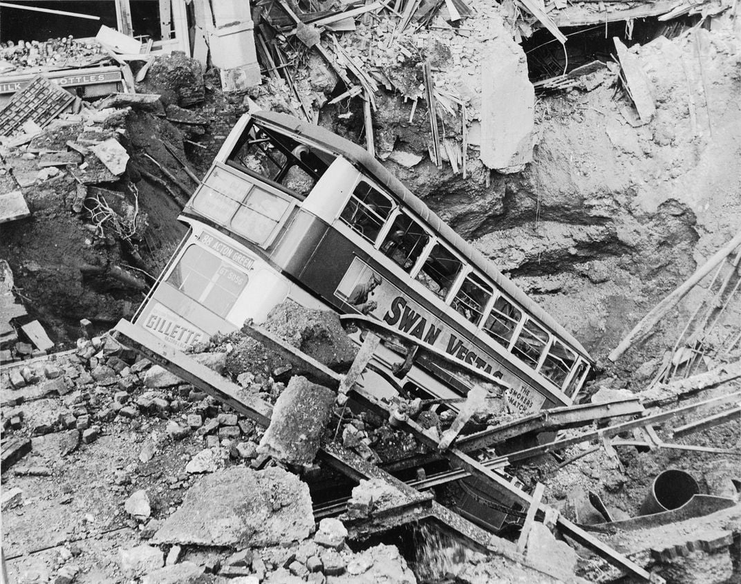 A bus lies in a crater in Balham in the aftermath of a bombing.