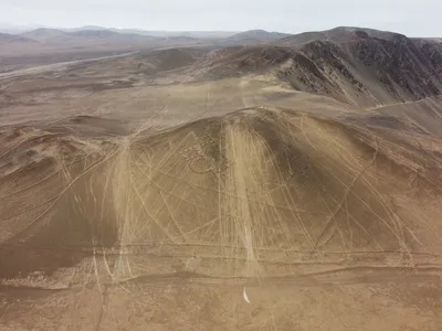 Lines from tire tracks can be seen running through historic geoglyphs in the&nbsp;Atacama Desert.