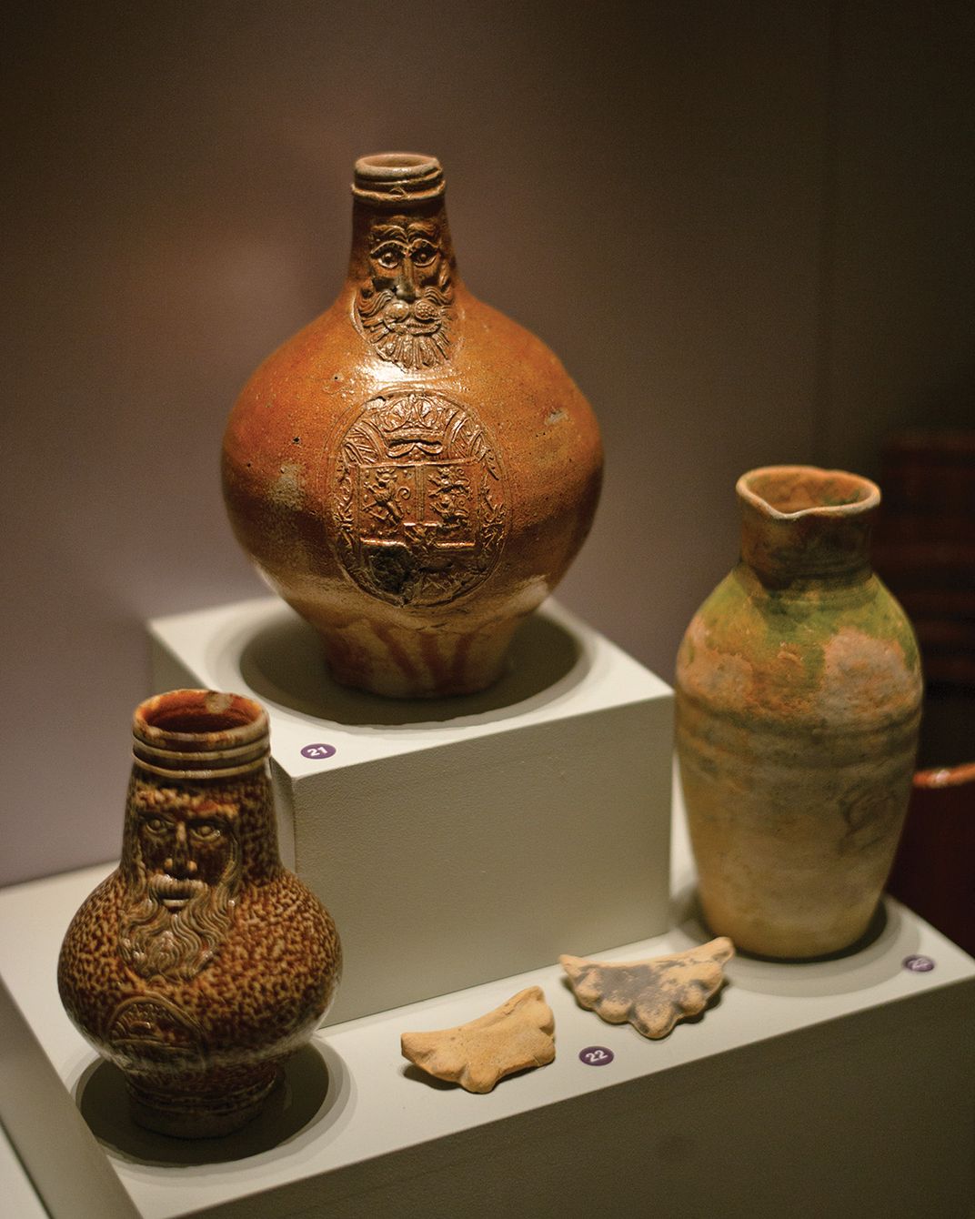 Two salt-glazed jugs, dating from 1580 and 1600 and found in the Sea Venture wreckage, feature a face associated with Robert Bellarmine, an Italian cardinal.