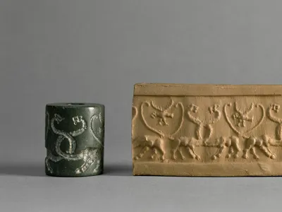 A cylinder seal (left) engraved with symbols that was used to press markings into wet clay (right)