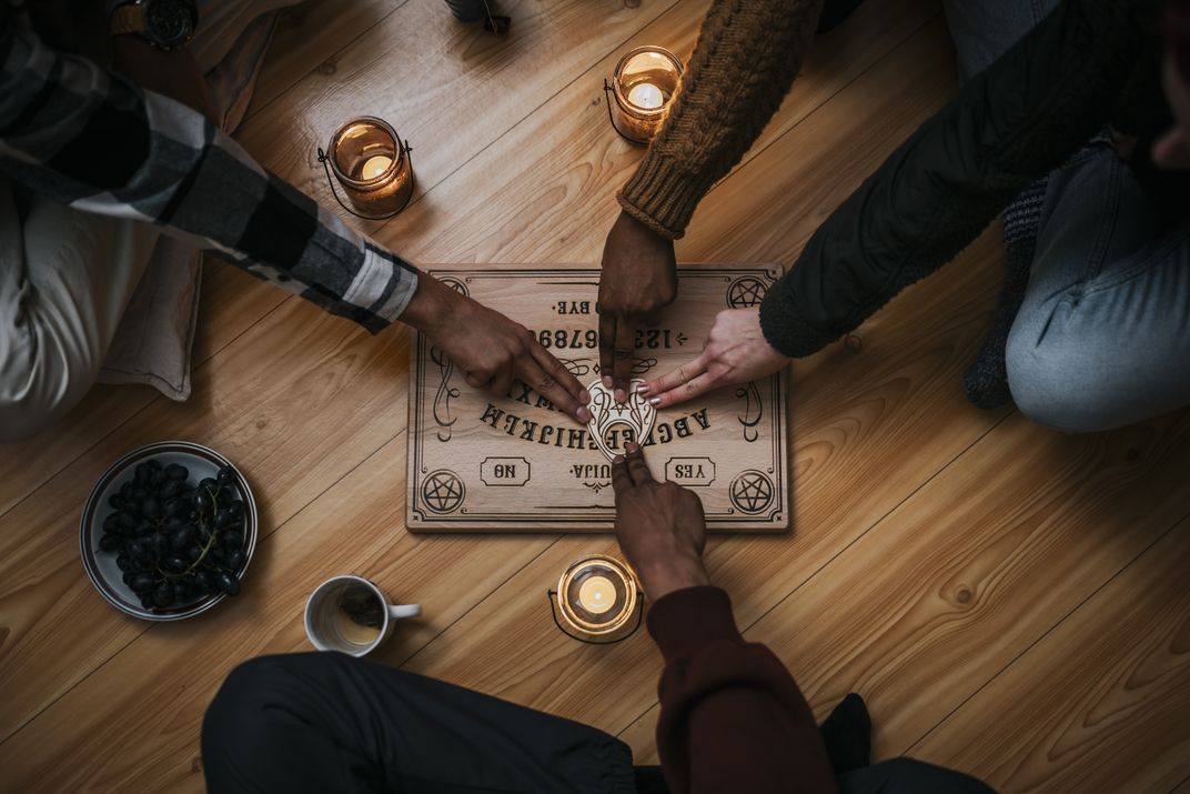 People around a Ouija board