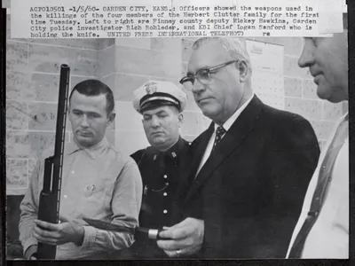 Officers display the weapons used in the November 15, 1959, killings of the Clutter family.