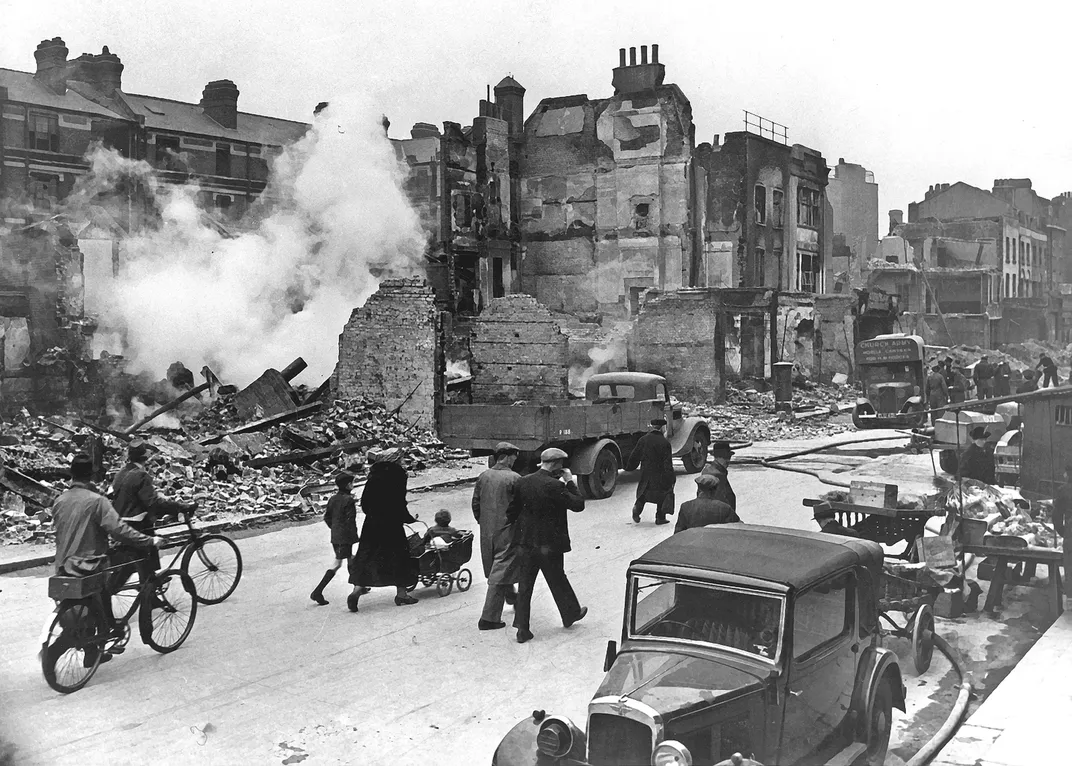 Civilians walk through a bombed-out street in London.