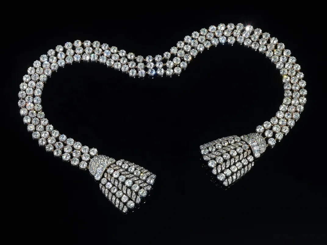 Diamond necklace laid out against a black background