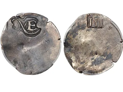 One side of the coin is stamped with a simple &quot;NE&quot; to represent New England, while the other side features Roman numerals to denote its value.